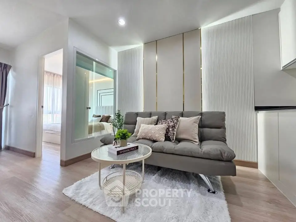 Modern living room with stylish decor and cozy ambiance in a contemporary apartment.