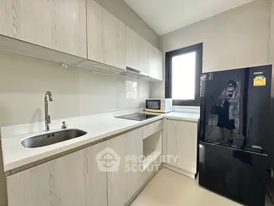Modern kitchen with sleek cabinetry, built-in appliances, and ample natural light.