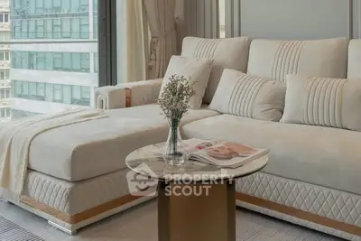 Luxurious modern living room with elegant sofa and glass coffee table, perfect for relaxation.