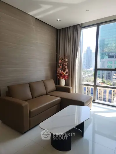 Modern living room with city view, featuring a sleek sofa and elegant coffee table.