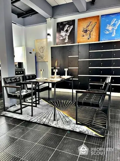 Modern industrial-style dining area with sleek black furniture and artistic wall decor