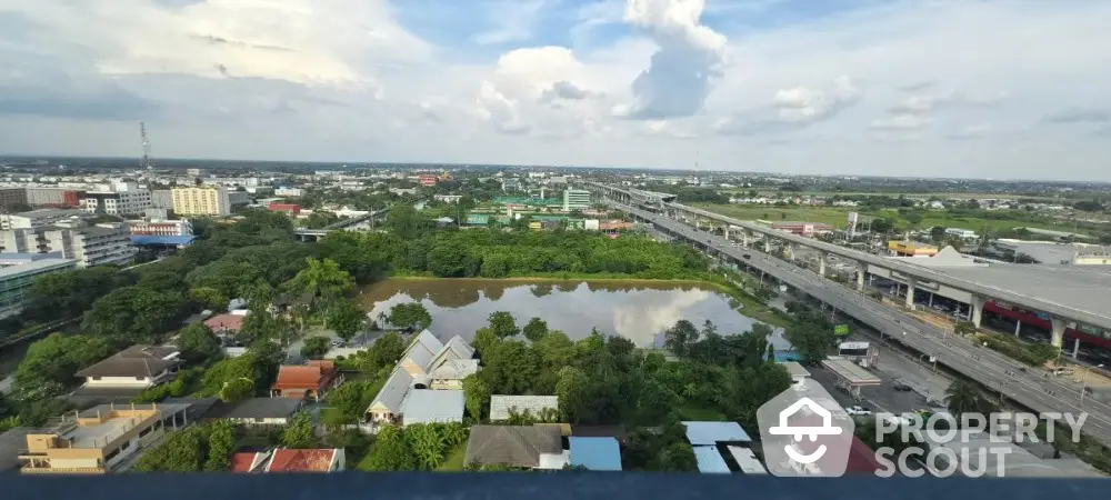 Stunning aerial view of urban landscape with lush greenery and serene water body