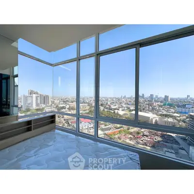 Stunning high-rise bedroom with panoramic city views and floor-to-ceiling windows.