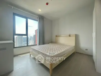 Spacious bedroom with city view in modern apartment