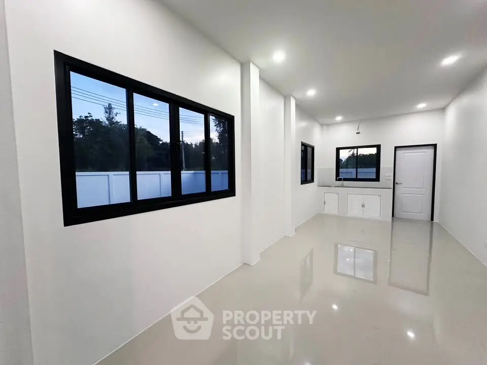 Spacious modern interior with sleek design and large windows for natural light.