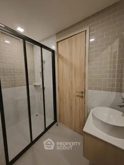 Modern bathroom with sleek shower enclosure and stylish sink