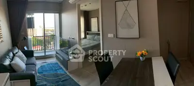 Modern apartment interior with living room, dining area, and balcony view.