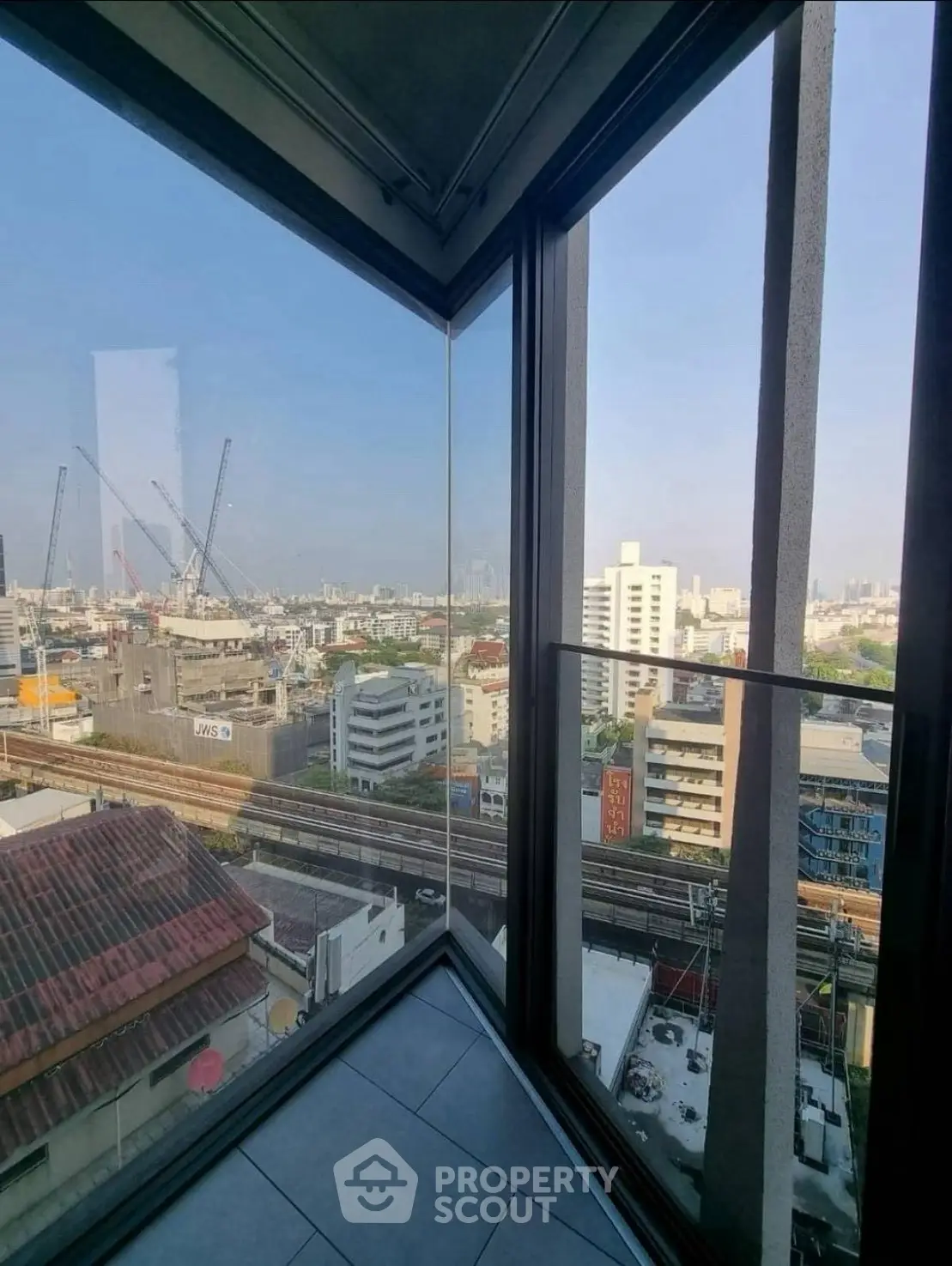 Stunning cityscape view from a high-rise corner unit with floor-to-ceiling windows.