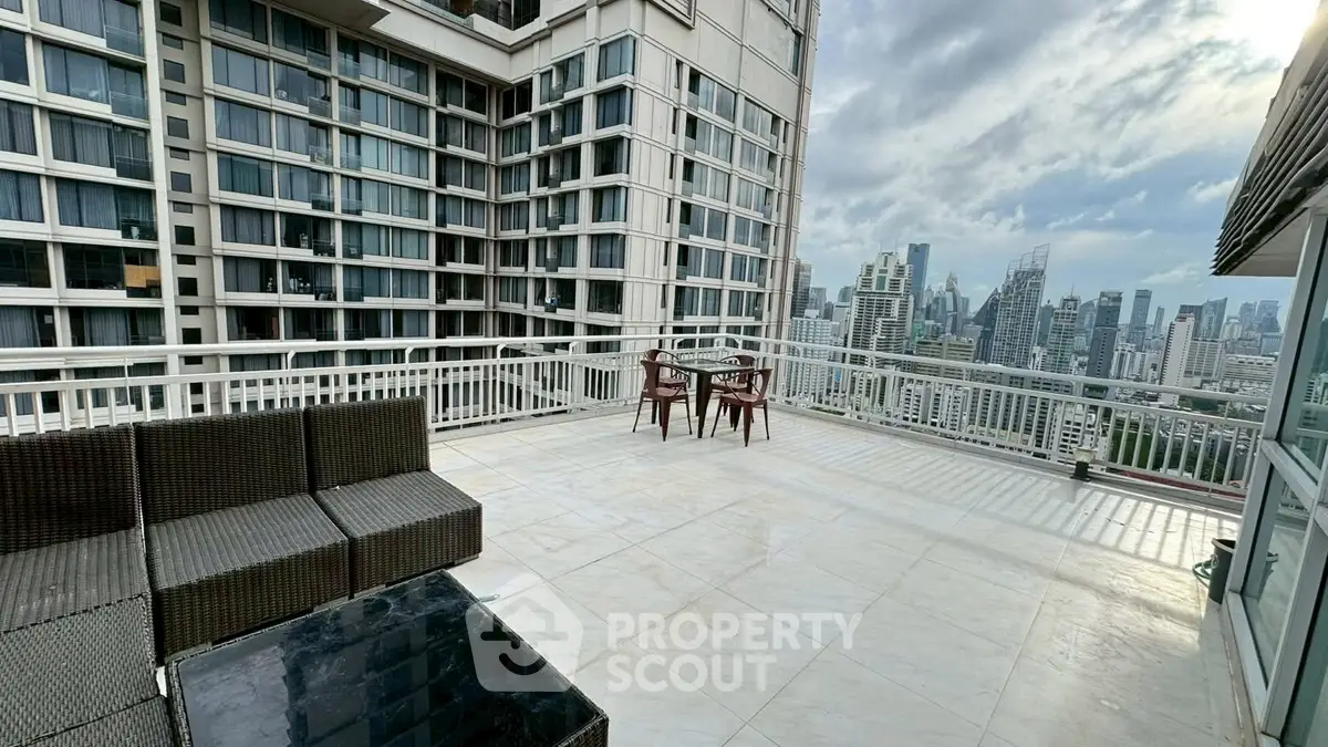 Spacious rooftop terrace with stunning city skyline views and modern outdoor seating.
