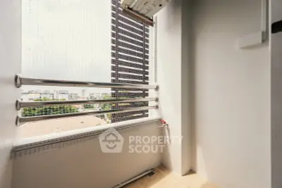 Spacious balcony with safety railing and city view, perfect for relaxation and enjoying the skyline.