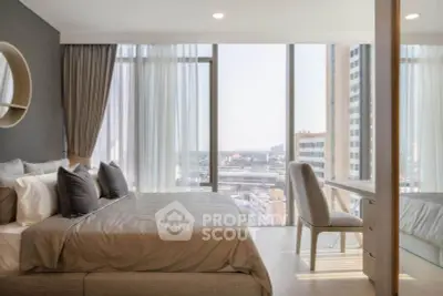 Luxurious bedroom with floor-to-ceiling windows offering stunning city views and elegant decor.