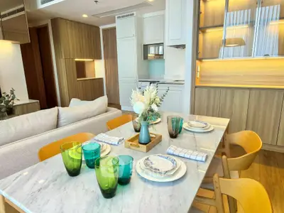 Stylish modern dining area with elegant table setting and open kitchen layout