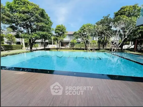 Luxurious residential pool area with lush greenery and modern design.