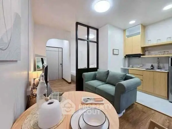 Charming open-layout living room with cozy kitchen and modern decor.