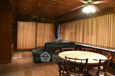Spacious living room with wooden ceiling and cozy seating area, perfect for relaxation.
