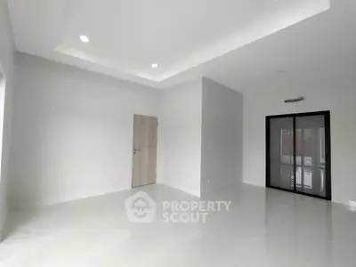 Spacious modern living room with sleek design and ample natural light.