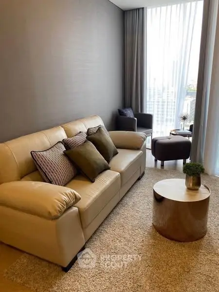 Modern living room with beige sofa and city view window