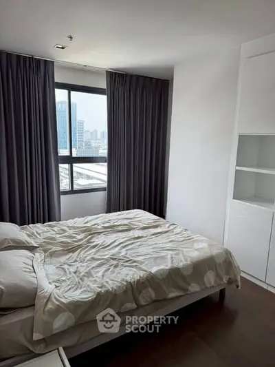 Cozy bedroom with city view and modern furnishings in urban apartment