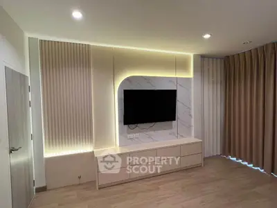 Modern living room with stylish TV wall and ambient lighting