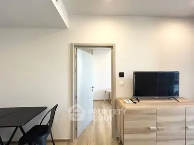 Modern interior with sleek furniture and open doorway in a stylish apartment.