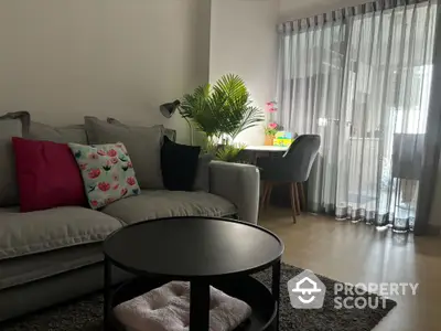 Cozy living room with modern decor and natural light from large window