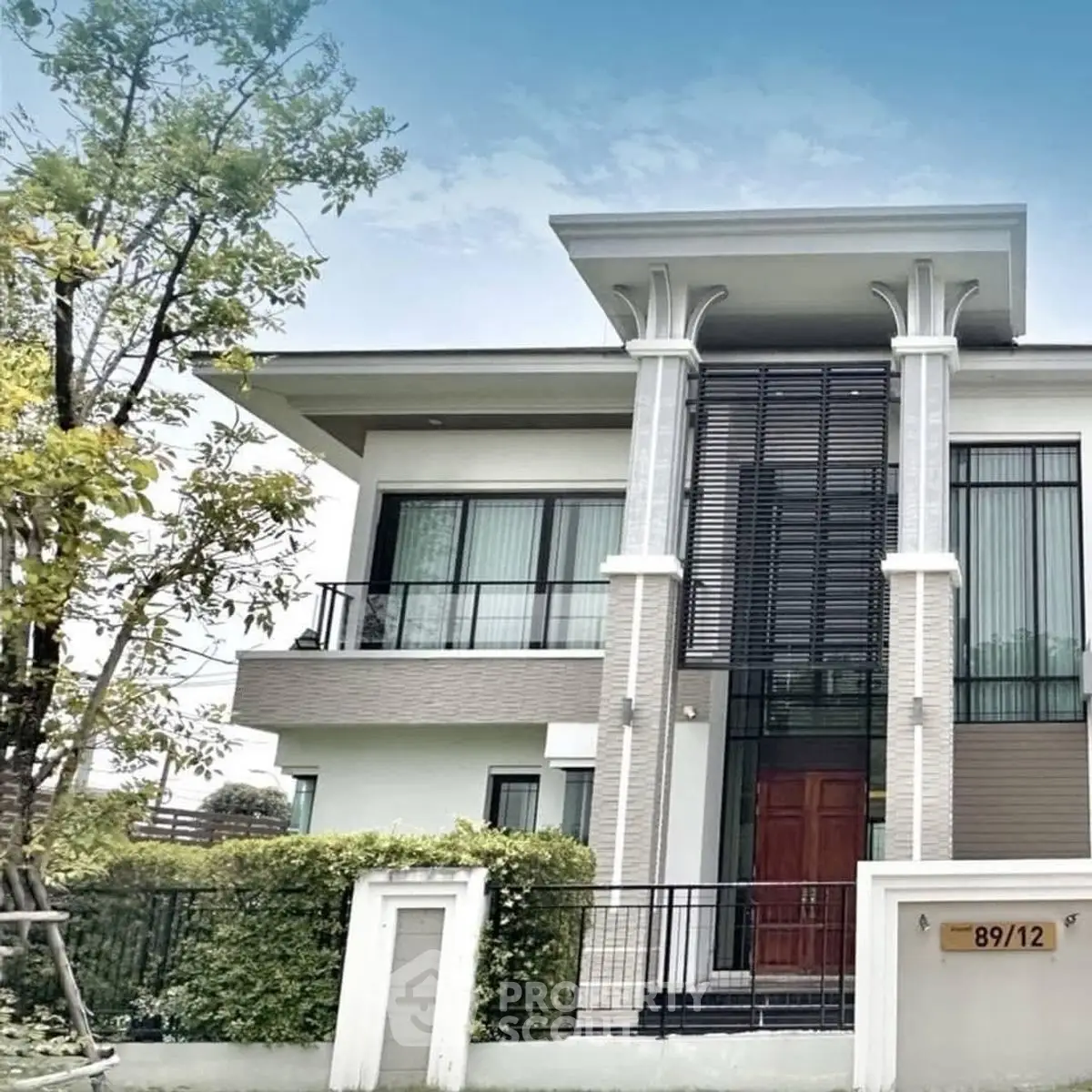 Modern two-story house with sleek design and lush greenery, perfect for contemporary living.