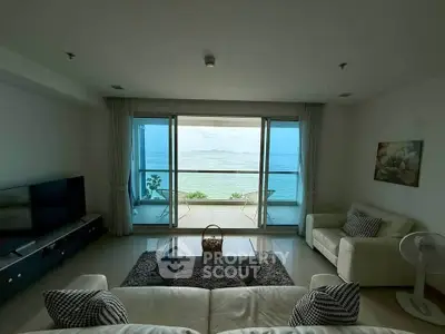 Luxurious living room with stunning ocean view and spacious balcony in modern apartment.