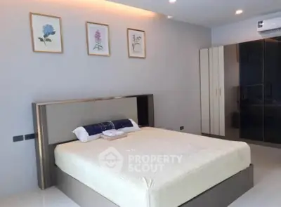 Modern bedroom with sleek design, featuring a large bed and stylish wardrobe, perfect for comfort and elegance.