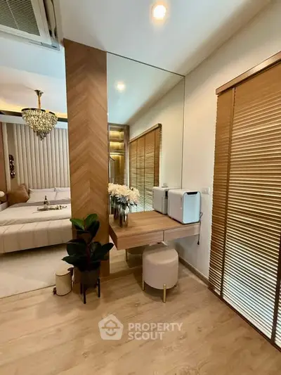 Luxurious bedroom with elegant decor and mirrored wall accent