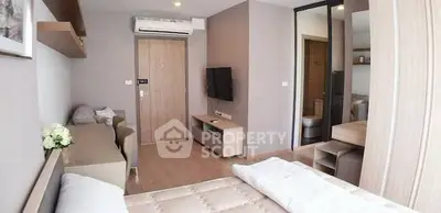 Modern bedroom with stylish decor and cozy ambiance, featuring a wall-mounted TV and air conditioning.