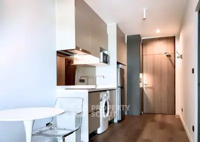 Modern kitchen with sleek appliances and washing machine in stylish apartment