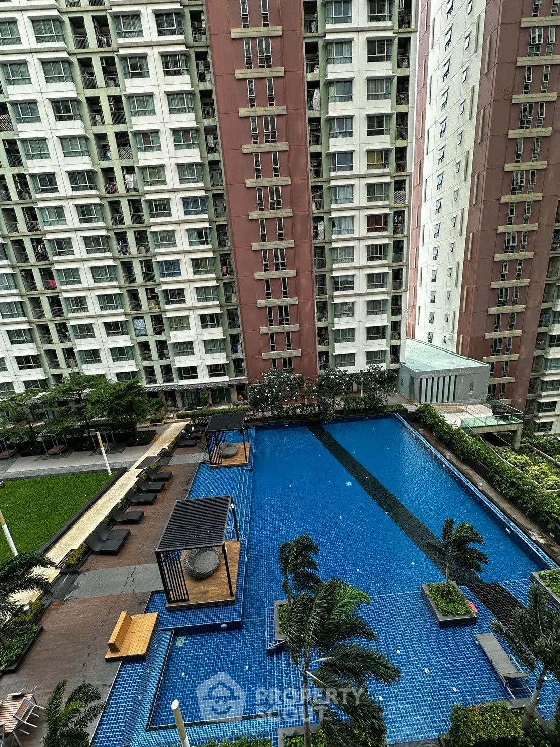 Luxurious high-rise apartment with stunning pool and garden view, perfect for urban living.