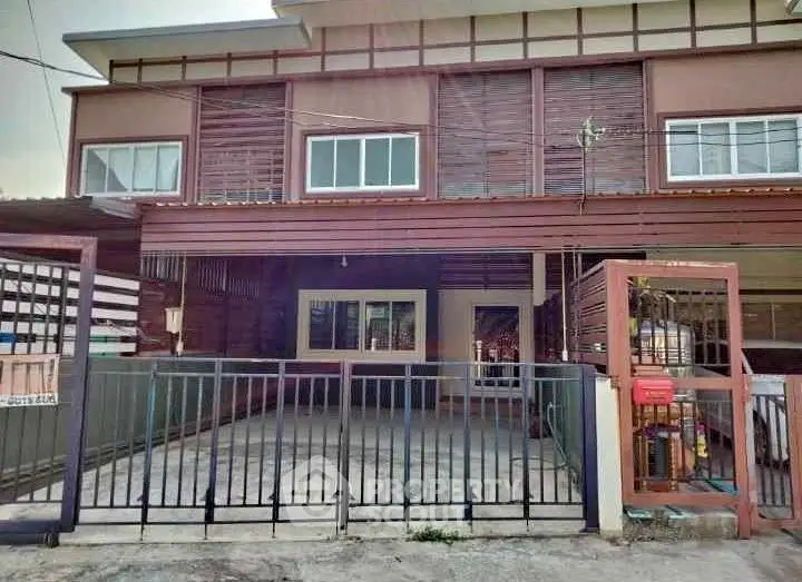 Charming townhouse with gated parking and modern facade in a serene neighborhood.