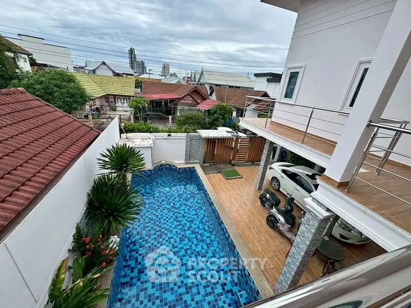 Stunning aerial view of modern home with private pool and spacious balcony, perfect for luxury living.