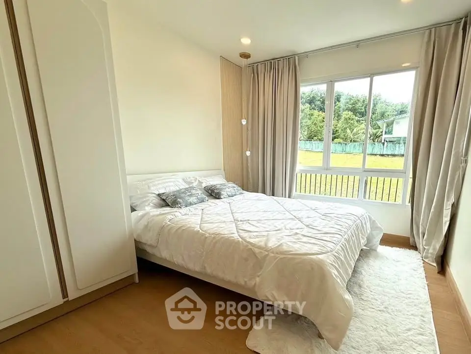 Bright and cozy bedroom with large window and elegant decor