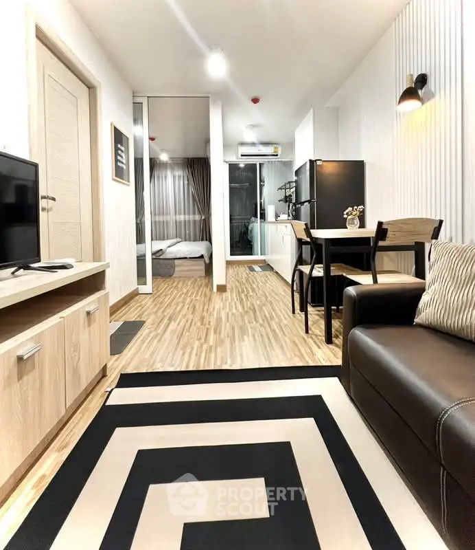 Modern open-plan living room with stylish decor and kitchen in a contemporary apartment.