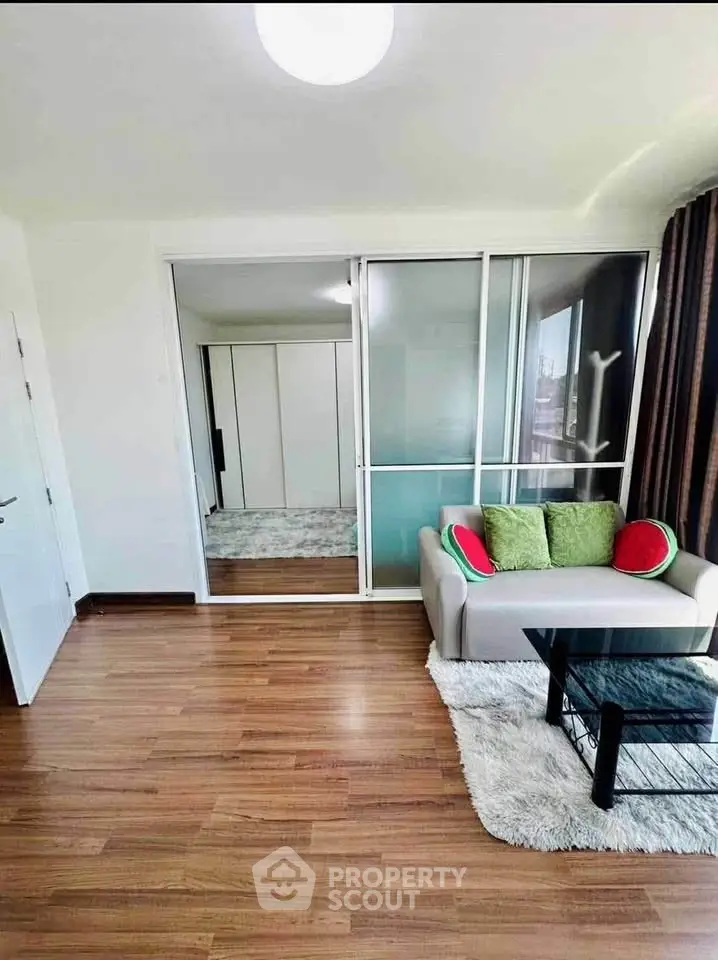 Modern living room with glass partition and cozy seating area