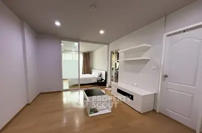 Spacious modern living room with wooden flooring and sleek furniture