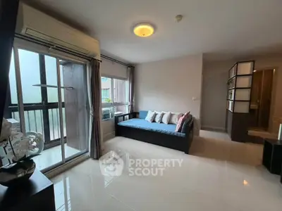 Spacious living room with modern decor and large windows for natural light