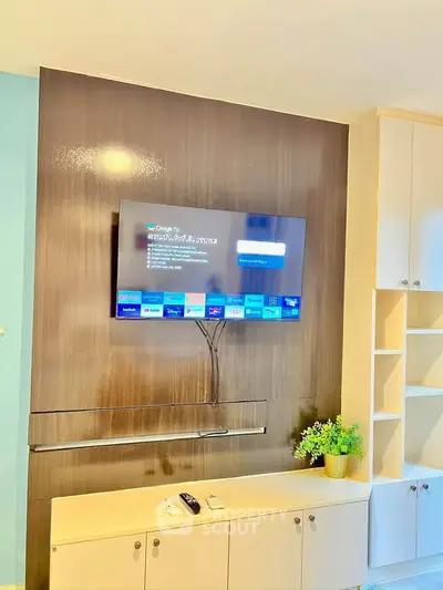 Modern living room with wall-mounted TV and stylish cabinetry.
