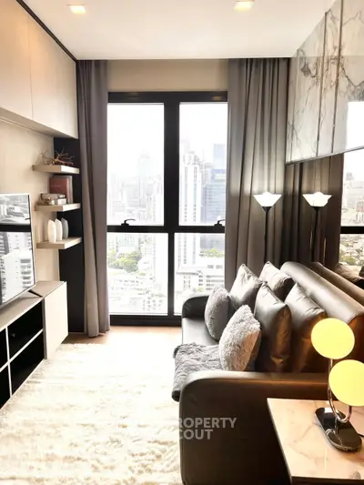 Modern living room with city view, cozy seating, and elegant decor in a high-rise apartment.