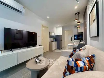 Modern living room with stylish decor and open kitchen layout in a cozy apartment.