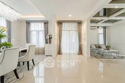 Luxurious open living and dining area with elegant decor and natural light.