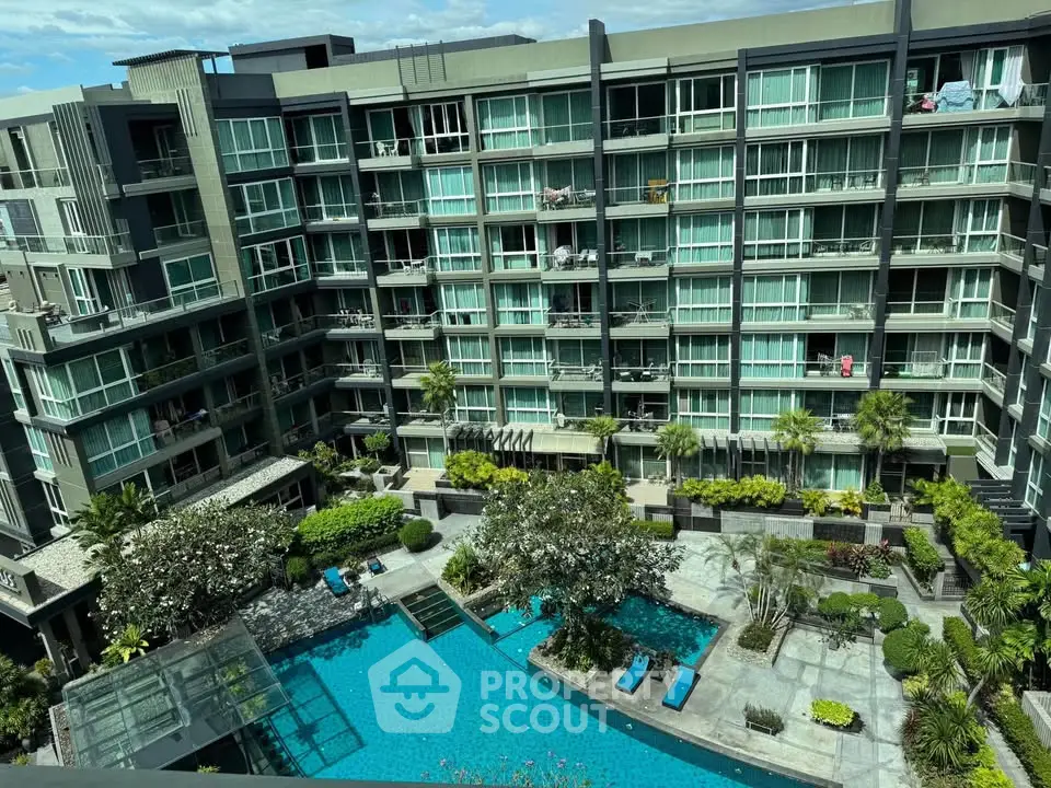 Modern condominium building with lush garden and inviting pool view