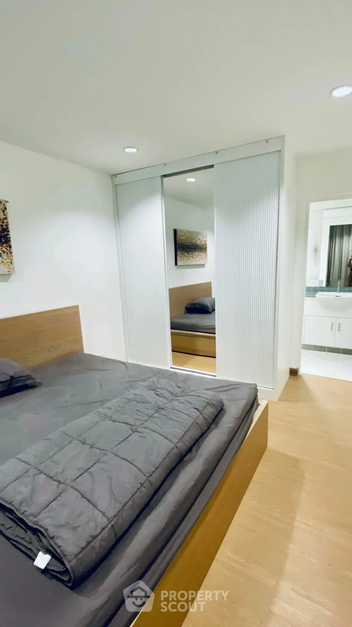 Modern bedroom with sleek design and mirrored closet doors