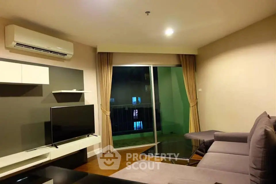 Modern living room with sleek furniture and balcony view