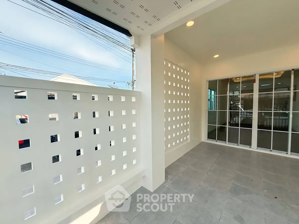 Modern exterior with stylish perforated wall and sliding glass doors