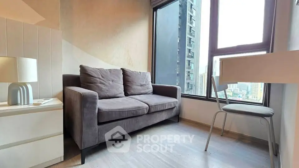 Modern living room with city view, cozy sofa, and stylish decor