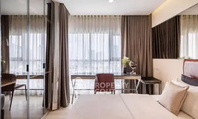 Modern bedroom with floor-to-ceiling windows and elegant decor