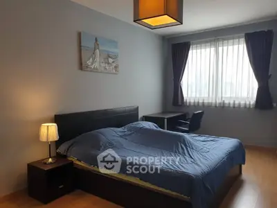 Spacious bedroom with modern decor and natural light